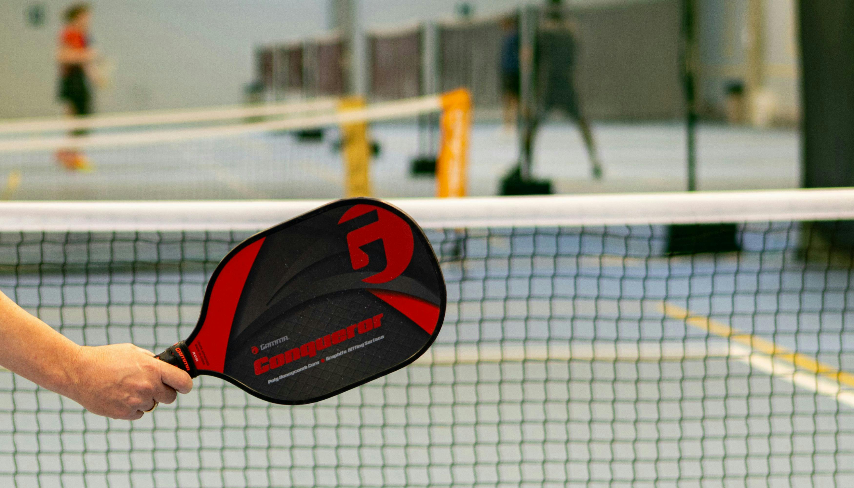 Pickleball paddle at the ready